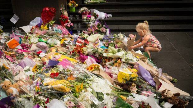 Hundreds of bunches of flowers were laid in Bourke Street in the wake of the tragedy. Photo: Chris Hopkins
