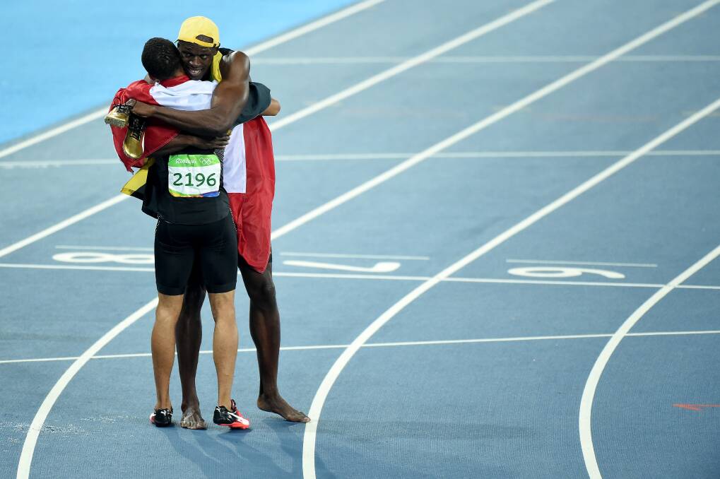 Usain Bolt of Jamaica, first place, and Andre De Grasse of Canada, third, celebrate after the Men's 100 meter final on Day 9 of the Rio 2016 Olympic Games at the Olympic Stadium on August 14, 2016 in Rio de Janeiro, Brazil. Photo: by Harry How/Getty Images