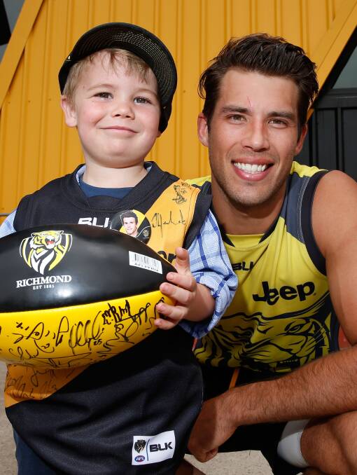 MEMORABLE: Scotsburn's Harry Mahar, 4, enjoys a day out with Tigers' players, including Alex Rance. Picture: Adam Trafford