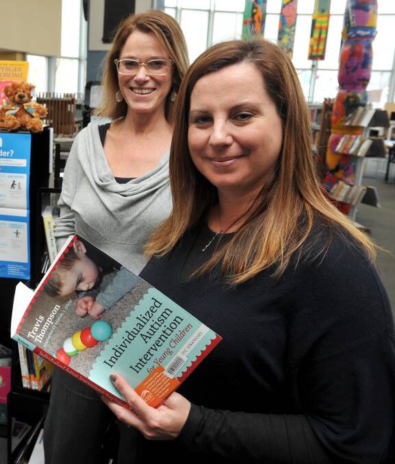 DONATION: Amaze librarian Maria Moren and community engagement project co-ordinator Pamela Catos with the new books. Picture: Lachlan Bence