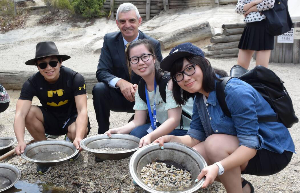 ON TOUR: Dalian University of Technology students Yusen Wei, Binglu Hu and Hui Wang, with Federation Business School associate dean of engagement Alan Labas, at Sovereign Hill. Picture: Erin Williams