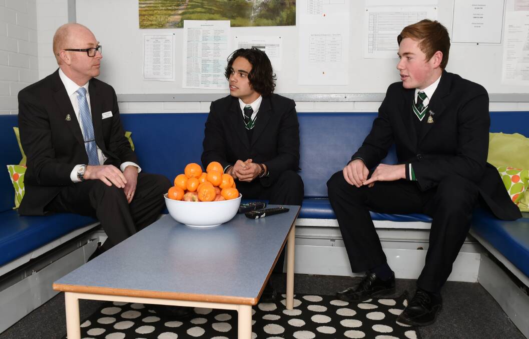 NEW ERA: St Patrick's College headmaster John Crowley with boarders Ethan Davies and Ben Hurley in one of the college's boarding houses. Picture: Kate Healy      
