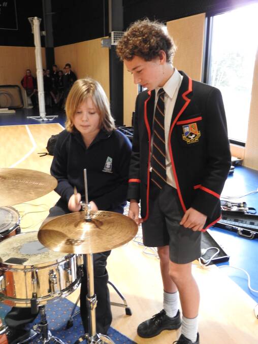 ON THE BEAT: Ballarat Clarendon College year 9 student Janek Grodzki points out the finer aspects of playing the drums to Emmaus Catholic Primary School year 5 pupil Declan Dwyer.