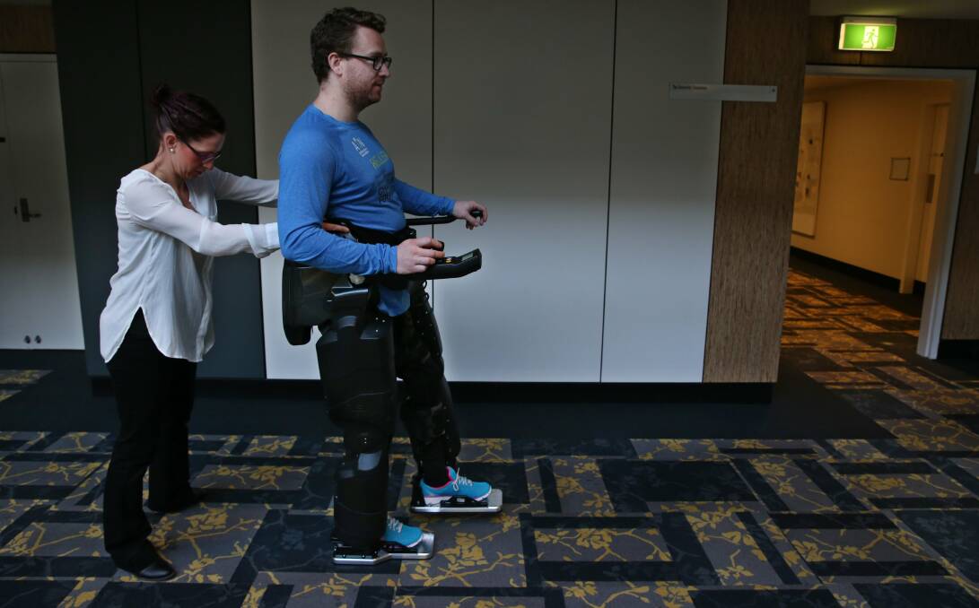 ON THE MOVE: Paraplegic Louis Rowe demonstrates the user-operated robotic legs, dubbed "Hellen", at the University of Newcastle. Picture: Simone De Peak