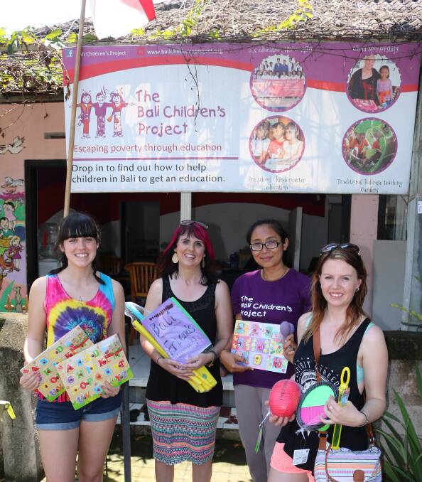 HELPING HAND: Chloe Waddell, Jodi Dorney and Stacey Corney with an employee from The Bali Children's Project after the donation was made. 