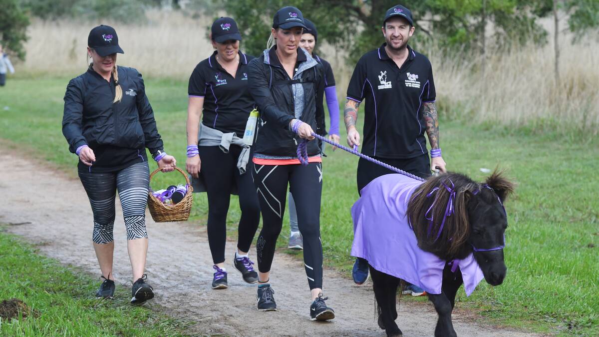 SYMBOL OF HOPE: Survivors of Suicide members walk with Hope the pony. Picture: Kate Healy 