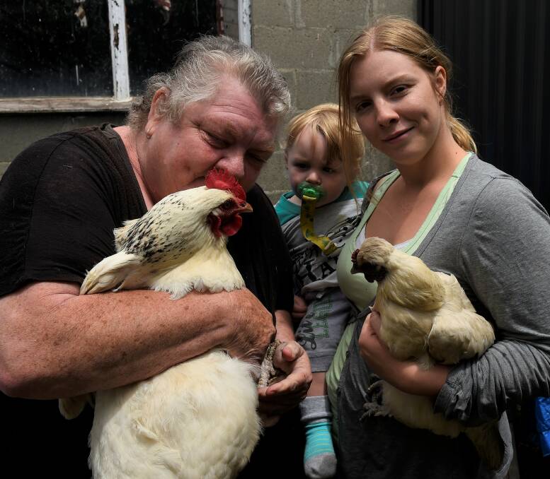 CHICKEN LOVE: Lesley Alexander, Kaiden and Tara Downing with the returned chickens. 