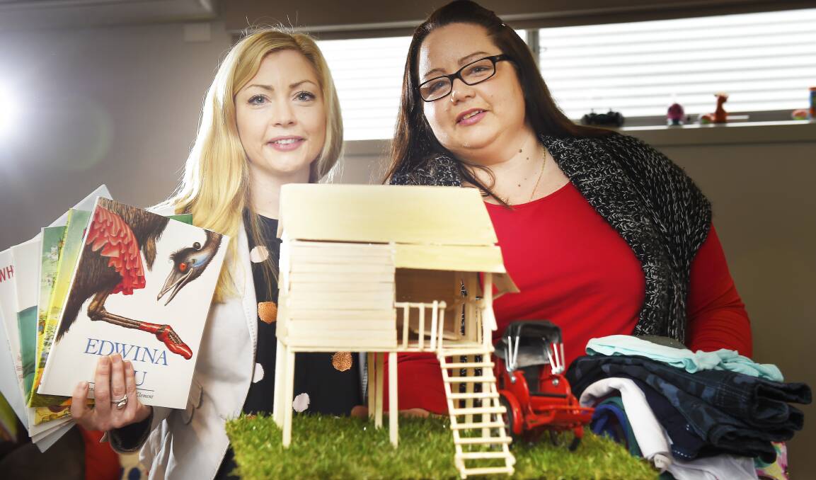 BUILDING TOWARD BETTER FUTURE: Alana Hannaford and Tameeka Rush with a model of the house they're set to build in Cambodia. Picture: Luka Kauzlaric 
