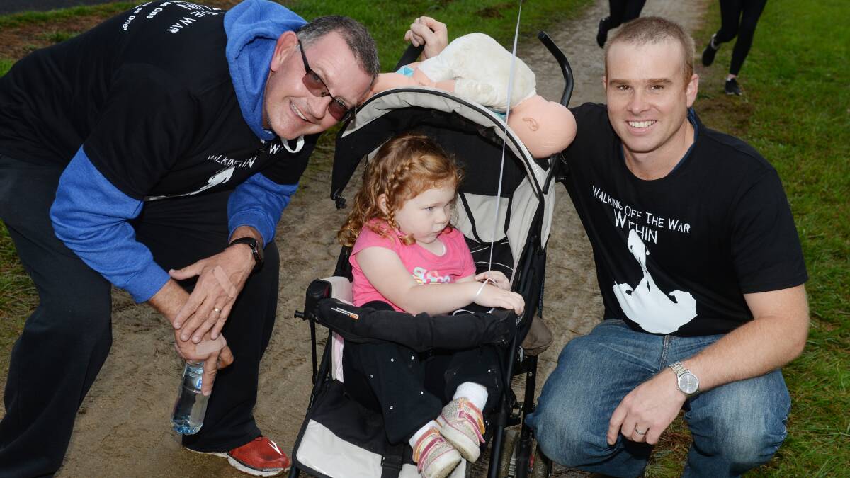 ALL TOGETHER: Daryl Chaplin, Lexi Cooper, 3, and Peter Cooper march together for Walk Off The War Within. Picture: Kate Healy 