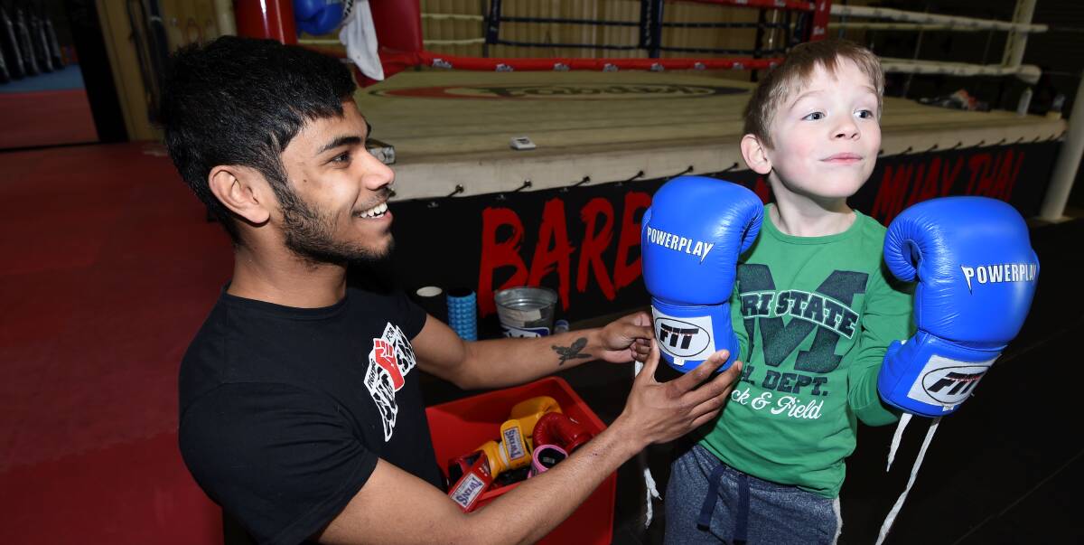 FIGHTING: Rishi Chisholm and Charlie Harris, 7, take to the ring in the Fighting for Autism classes. Picture: Lachlan Bence 