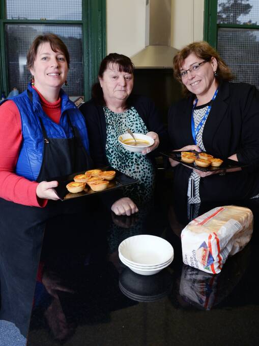 FOOD WARMS HEARTS: Volunteers of Creswick Community Dining Alison Andrew, Judy Micallef and Joanne Bott cook up a storm for those in need. Picture: Kate Healy 