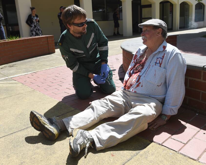 MOCK BOMB SCENARIO: ACU paramedicine students treat a mock casualty during their training scene. Picture: Lachlan Bence 
