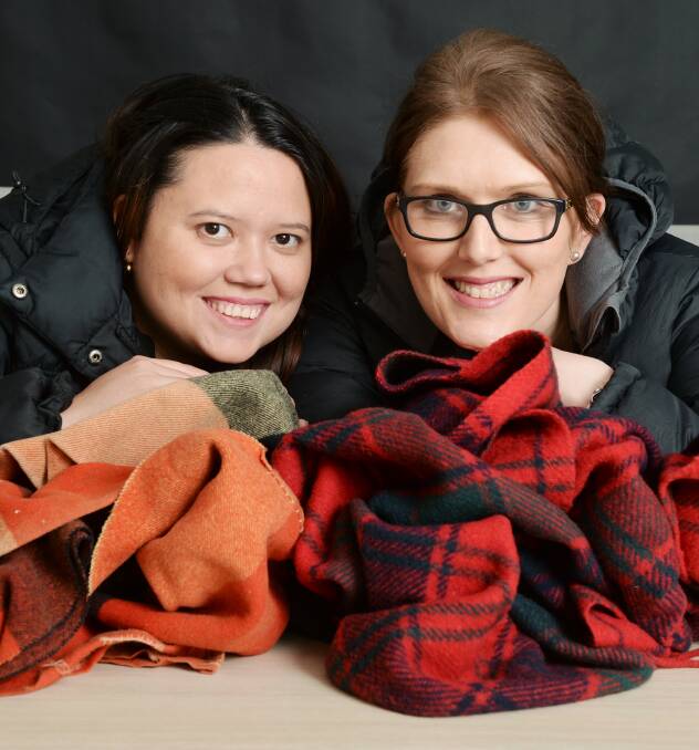 WARM: Ballarat Young Ambition Rotary Club members Jane Jens and Emily Sweet are calling for donations of winter woollies and blankets. Picture: Kate Healy