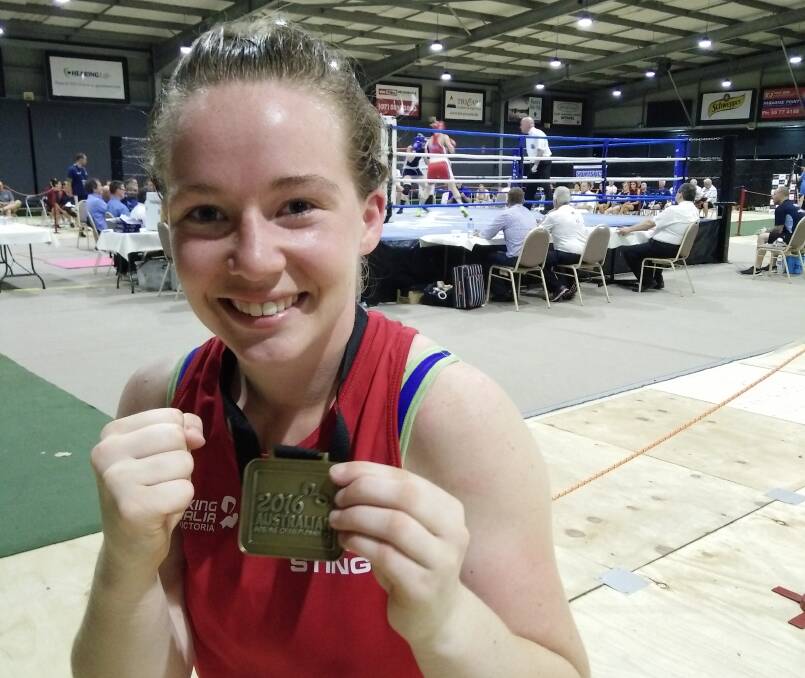 STING LIKE A BEE: Boxer Cassandra Axon celebrates her victory in the 57-kilogram division at the boxing national championships. Picture: Supplied