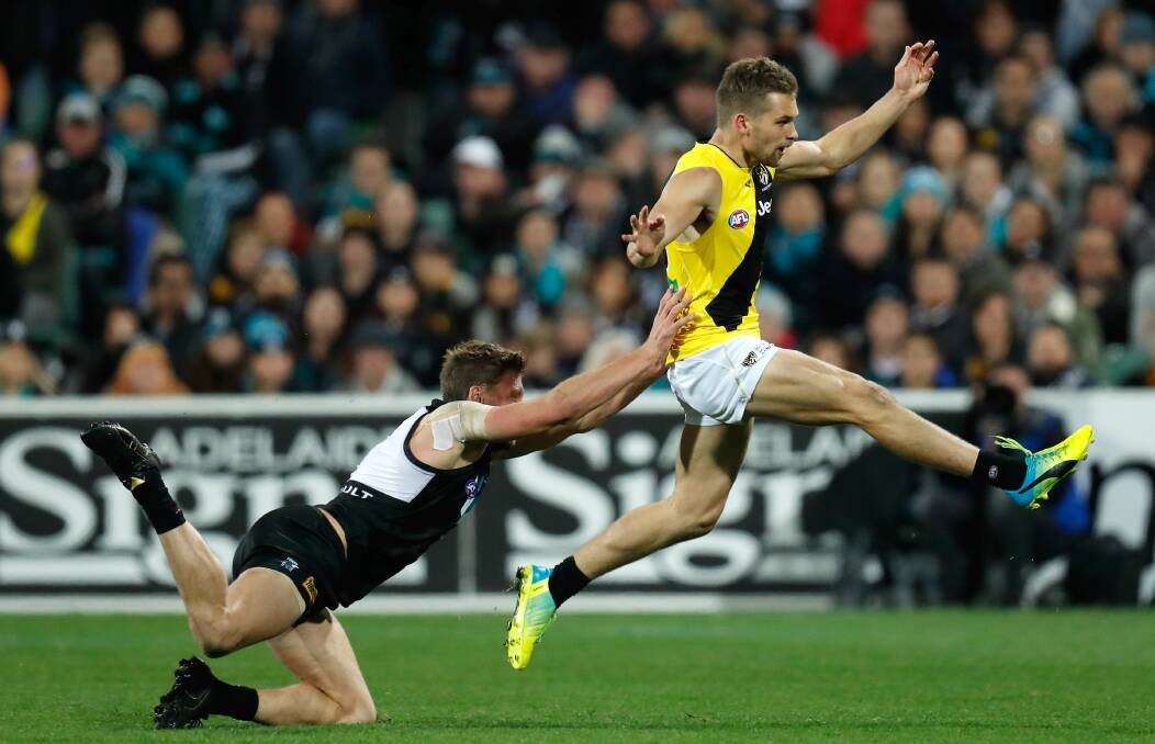 POETRY IN MOTION: Dan Butler kicking a crucial goal against Port Adelaide after taking several running bounces. Photo: Getty Images.