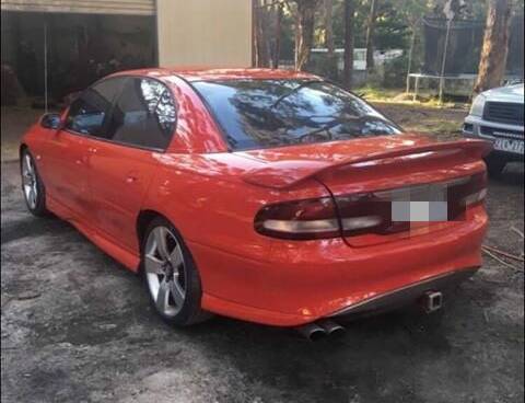 The red Holden Commodore in question before the crash.