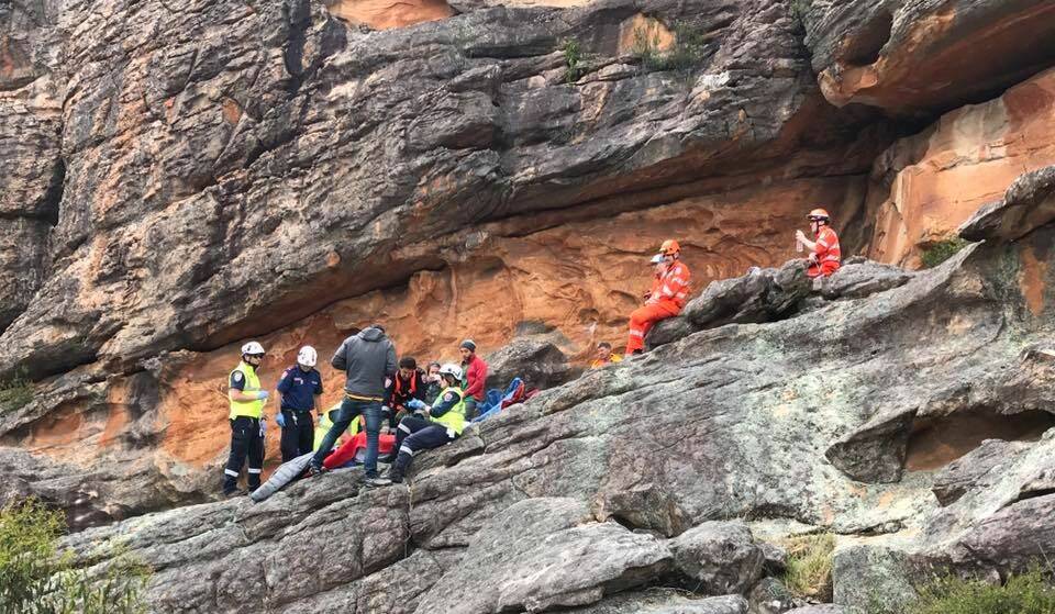 CLIFFHANGER: Emergency crews rescue an injured rock climber at Mount Zero on Saturday morning after he fell more than two metres, suffering a laceration to his face.