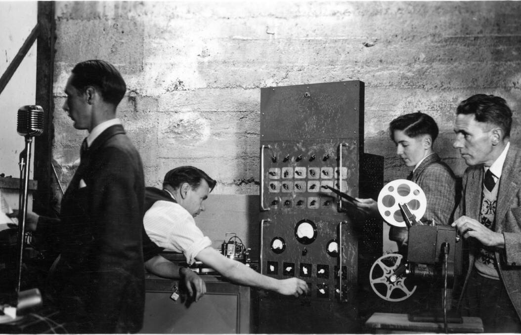Denzil Howson (left) records his narration while recording engineer Jack Brittain operates the disc recorder, George Cox works on sound effects and Alex Wilkins screens the film. 