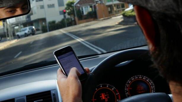 At least a quarter of drivers say they text while driving. Photo: Ken Robertson