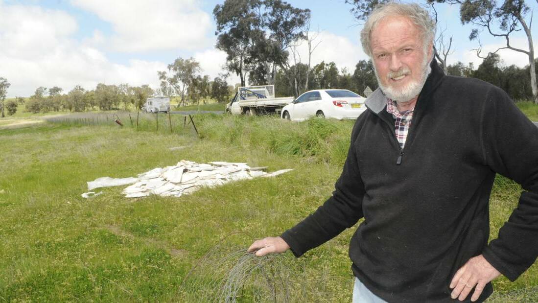 James Stewart's father, Peter Stewart, with asbestos laden material left behind at the propery after a road accident recently. Photo:CHRIS SEABROOK 