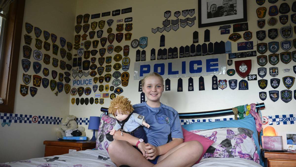 Dakota Bradley in her police-decorated bedroom.