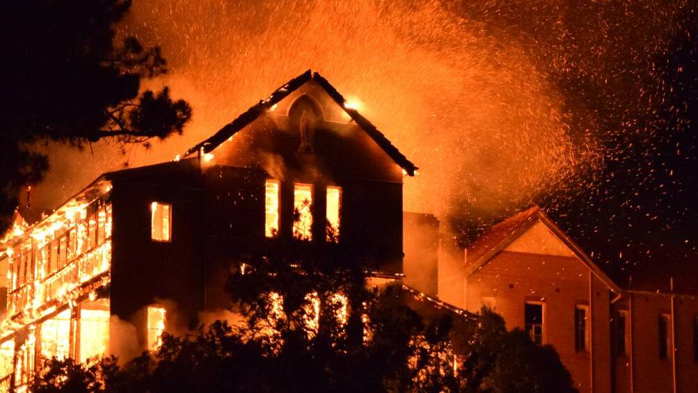 INFERNO: The roof of the former St John's orphanage building exploded as the building erupted in flames on Friday night. Photo Hans Rebhandel. 