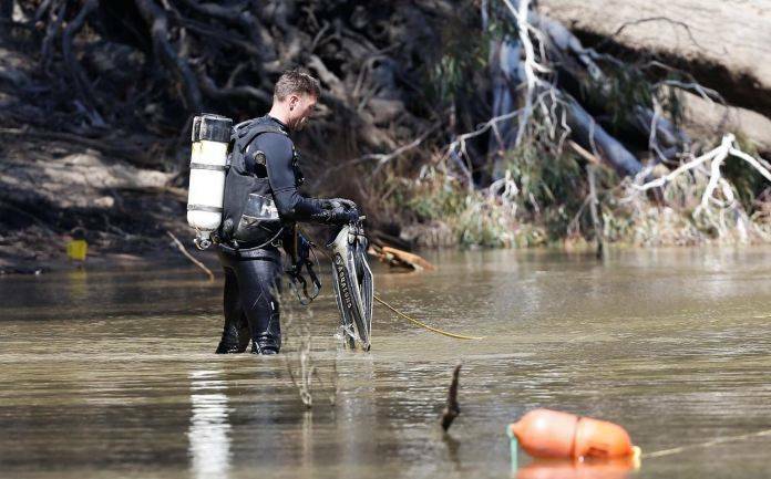 Police divers search the Murray River for the five-year-old on Friday. Picture: LUKE HEMER, RIVERINE HERALD
