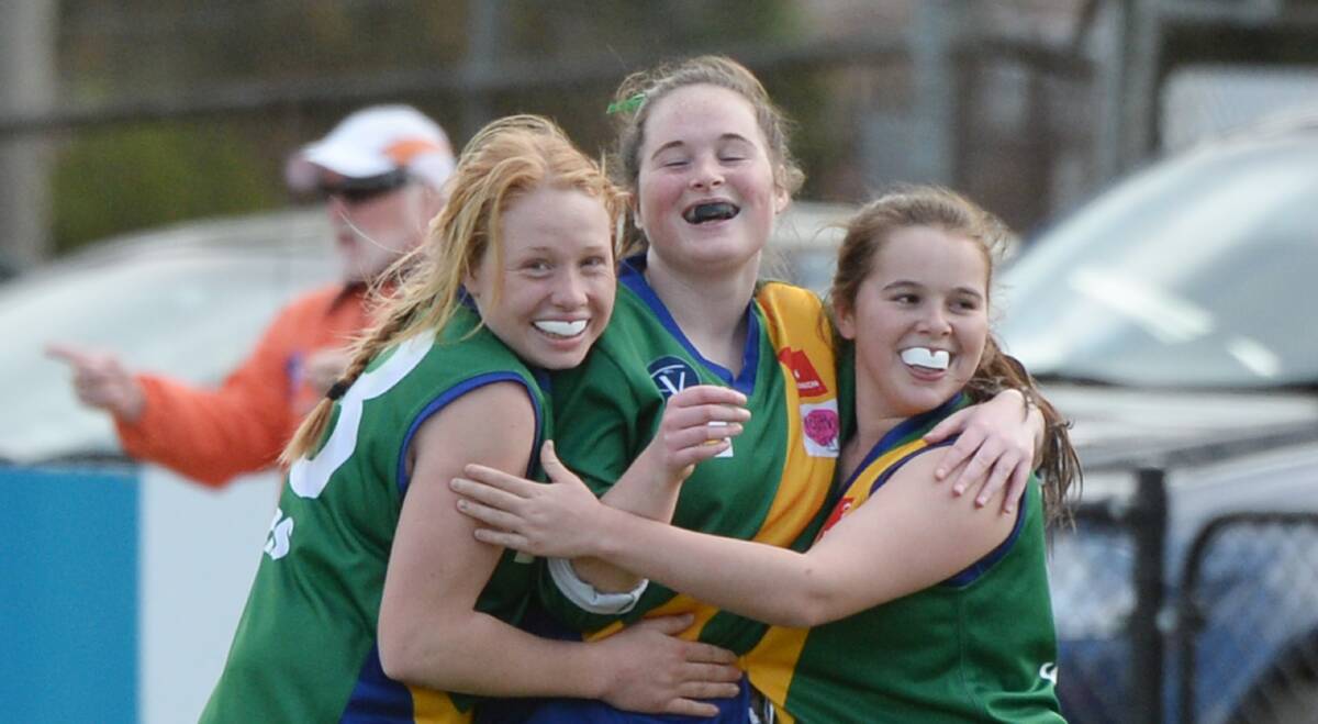 ULTIMATE GLORY: Lake Wendouree's Amy Jackson, Tylah Bruhn and Faith Greenhalgh celebrate the BFL youth girls premiership. Picture: Kate Healy