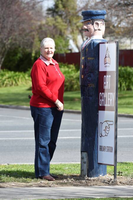 TEST RUN: Beaufort Art Trax Gallery's Anne Beer catches up with Harry the stationmaster, who was a trial for future bollard potential in the town. Picture: Lachlan Bence