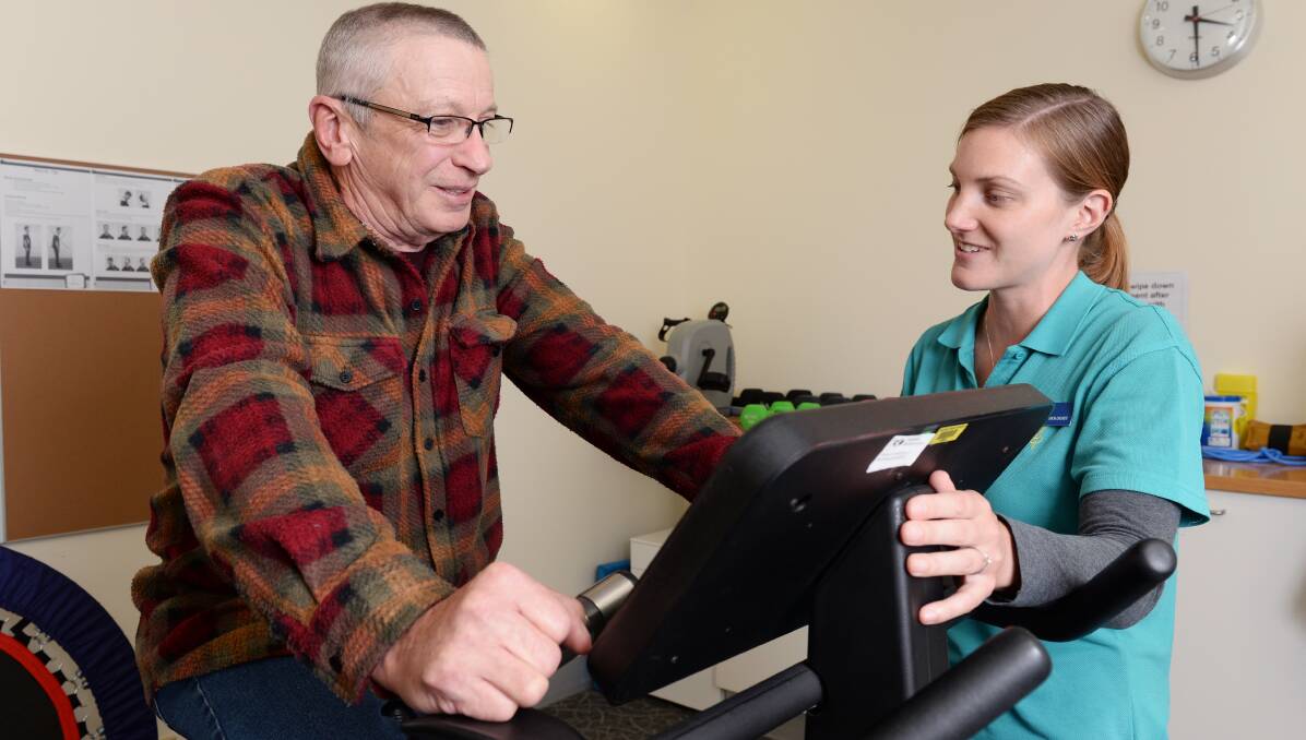 STRONGER: Barry Crick relishes his post-radiation exercise program under close watch of exercise physiologist Jessica Seater. Picture: Kate Healy