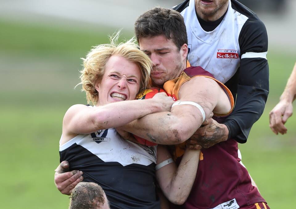 GOTCHA: Sam Williams (North Ballarat City) is tackled by Callum Currie (Redan on Saturday. Picture: Lachlan Bence.