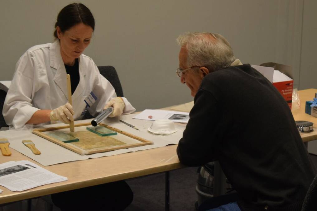 CARE: Conservators can provide advice on keeping items, like this map. To book: http://arts.unimelb.edu.au/grimwadecentre/engagement/war-heritage- roadshow-2017.