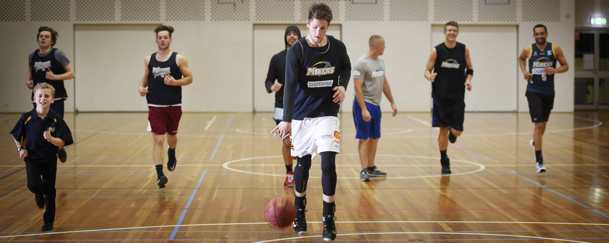 UNITED FRONT: Miners captain Kris Blicavs leads his team through warm-ups at training on Thursday night ahead with finals looming. Picture: Luka Kauzlaric
