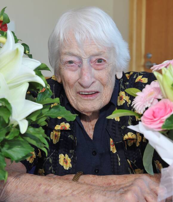 SPECIAL DAY: Beautifully coloured flowers, and strictly no tinsel, surround Molly Saint for her 100th birthday, which she shares with Christmas Day. This time, celebrations were all about Molly. Picture: Lachlan Bence
