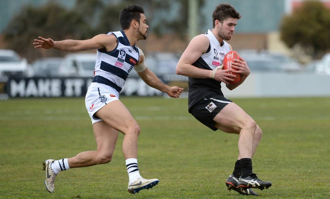 CONTROL: Cat Zac Bates may be on the prowl, but Rooster Tony Lockyer is all poise in defence at Eureka Stadium on Saturday. Picture: Kate Healy