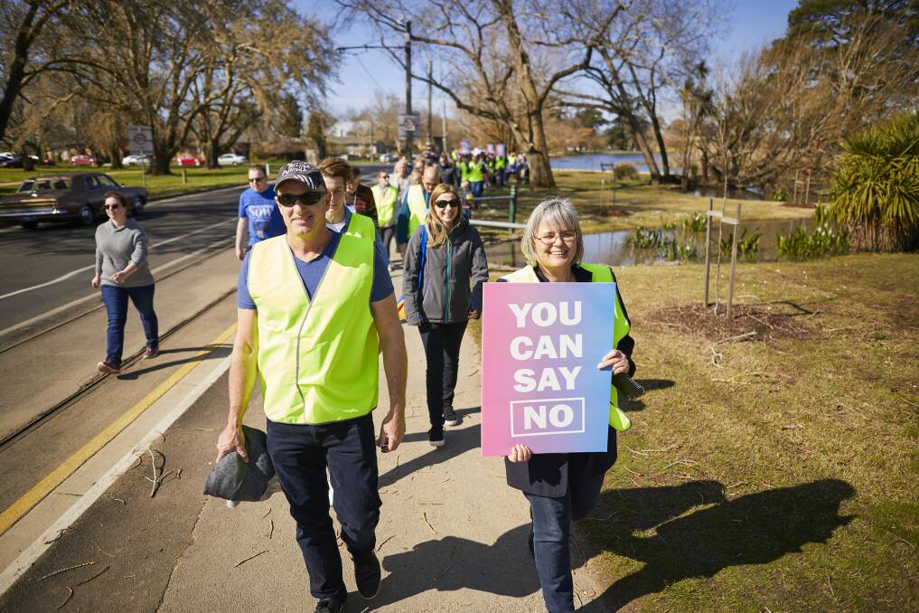 NO: Family Value Alliance Ballarat coordinator Dianne Colbert leads about 100 people in a short, quiet lakeside protest on Sunday afternoon. Pictures: Luka Kauzlaric