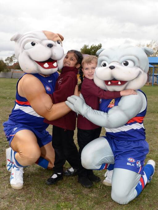 PUPPY LOVE: Wendouree Primary preps Harleen Ghuman and Jaylen Mahrtens find a cuddlier side to mascots Butch and Woofer. Picture: Kate Healy