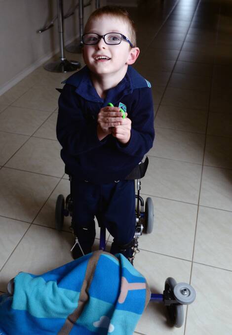 HOPE: Archie Sims walks and runs independently in his custom-fit walker and can now access specialised physiotherapy in Australia's first regional service. Picture: Kate Healy