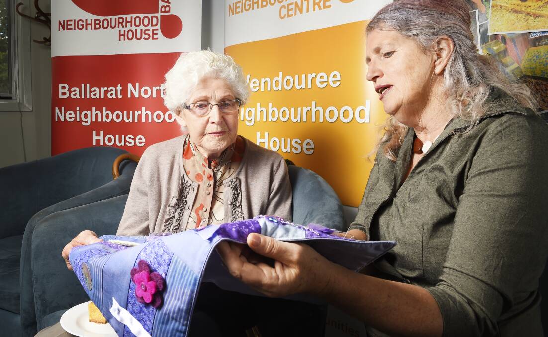 SHARING: Yvonne Bedford and artist Christine Hickson talk over artwork at the 100 stories project launch on Tuesday morning. Picture: Luka Kauzlaric