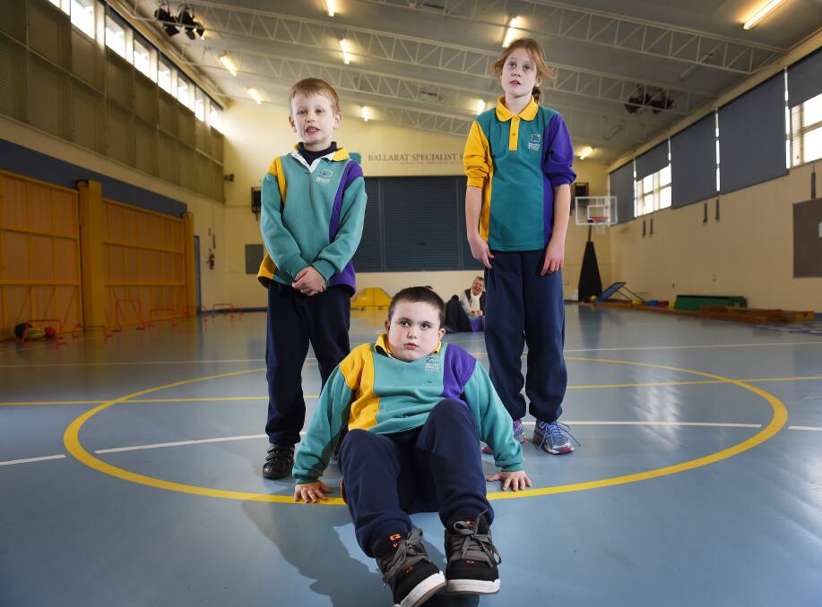 SUPPORT: Ballarat Specialist School pupils Toby, Jessie and Emma have fun wearing their trackies to raise awareness for sick kids in hospital. Picture: Luka Kauzlaric