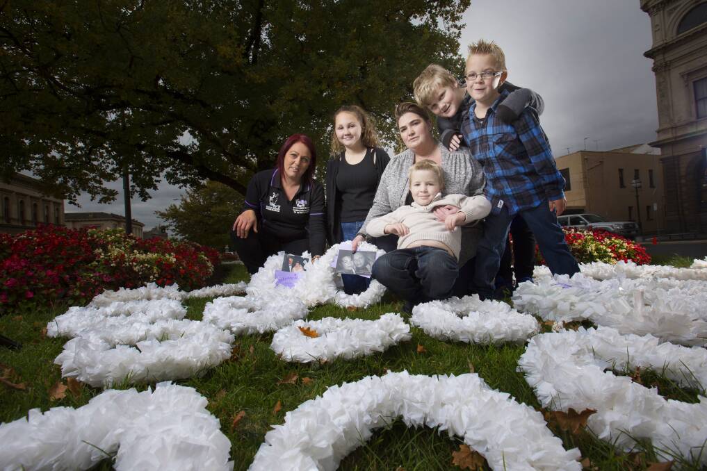 MEMORY: Survivors of Suicide founder Kristy Steenhuas with Jiordyn (aged 12), Beck Waight, Nate (5), Roarke (10), and Daynon Laxton (7) lay white wreaths outside Ballarat Town Hall last year. Picture: Luka Kauzlaric