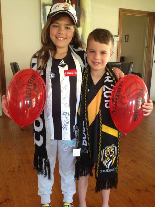 Marli Russell, 8 and younger brother Jarvis, 6, with the Sherrin-endorsed balloons their father Mick created. Pic: contributed.