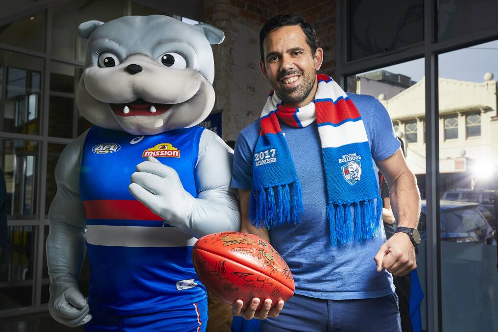 PACK SUPPORT: Western Bulldogs mascot Woofer with former Bulldogs player Brett Goodes are calling for as many Ballarat people as possible to fill Eureka Stadium to create a true AFL home-ground advantage for the August 19. Picture: Luka Kauzlaric