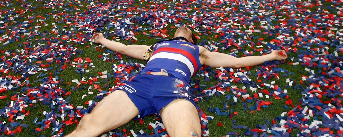 ATMOSPHERE: Western Bulldogs' stand-in skipper Easton Woods revels in confetti after collecting his premiership medallion. Picture: Getty Images