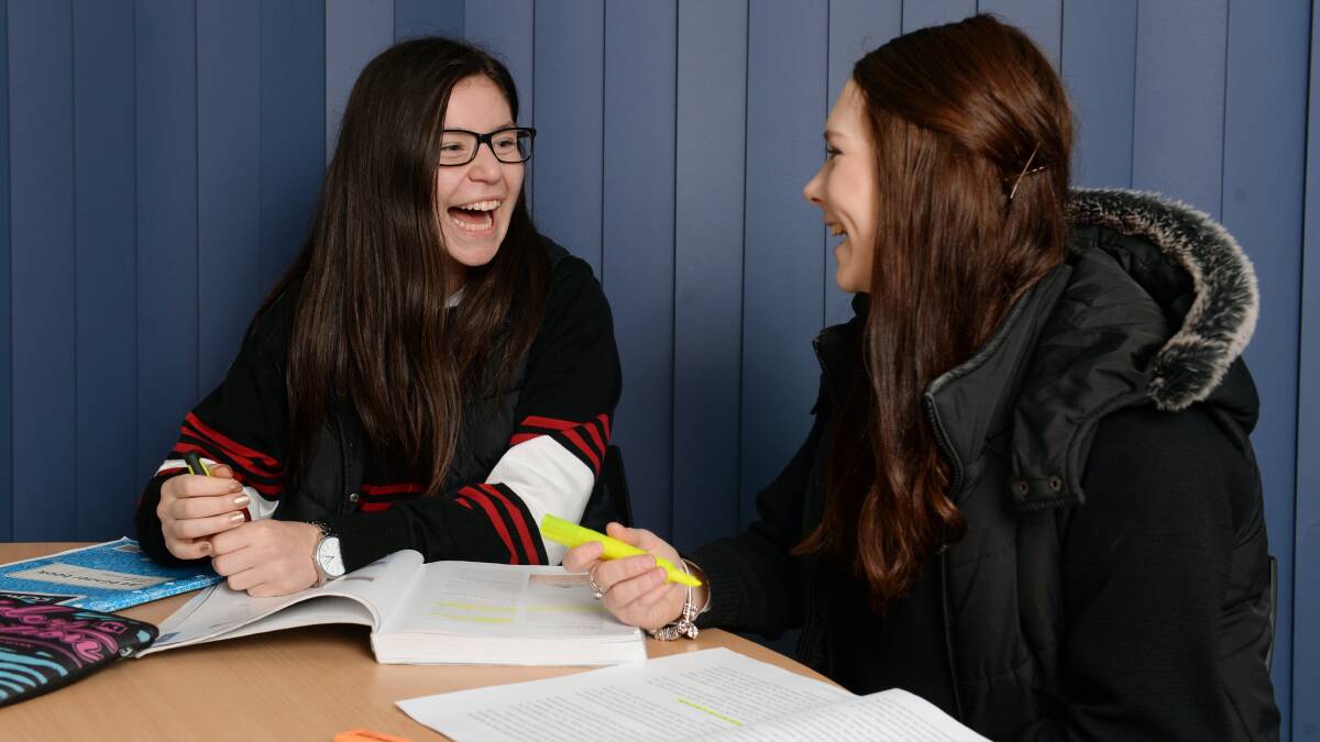 Emma Milesevic shares a laugh with school friend Catherine Owen. Picture: Kate Healy
