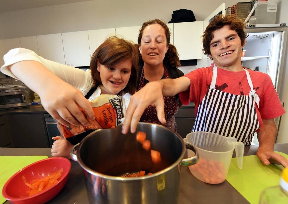 RIGHT INGREDIENTS: Brigitte Wilson and Rodney Donovan-Clancy cook soup under the eyes of Pinarc support worker Jodie Goldring in the program's temporary Ballarat Community Health base. Picture: Jeremy Bannister