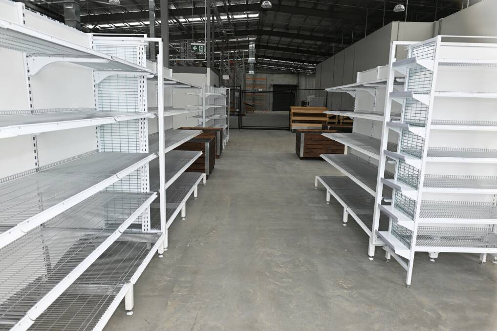 Shelving being set up in early November 2023 now allows for a supermarket-like feel for FedUni students in a pilot partnership program with FoodBank. Picture by Lachlan Bence