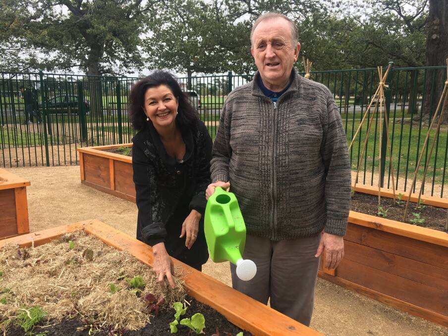 TEAM EFFORT: Mayor Samantha McIntosh and Berni, from McCallum's horticultural program prepare garden beds in the new project in the inclusive playspace.