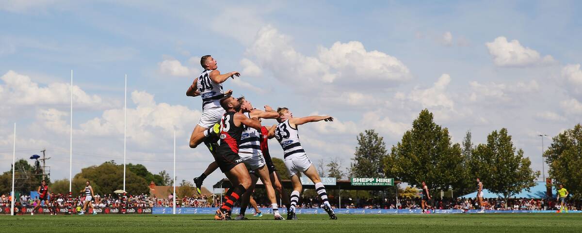 BUSH FOOTY: Big Cat Nathan Vardy puts on a high-flying spectacle in Shepparton with Geelong playing Essendon this summer. Picture: Getty Images