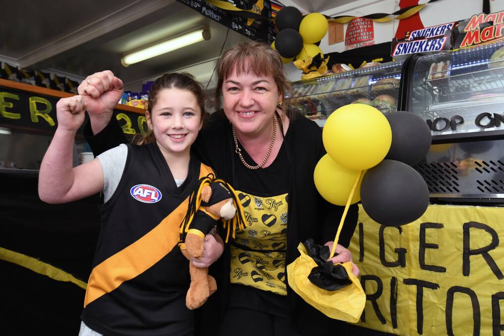 Kylie Beaumont and seven-year-old Sophie Moody have turned Coronet Breakfast and Lunch Bar into Tiger Tuck Shop. Picture: Kate Healy